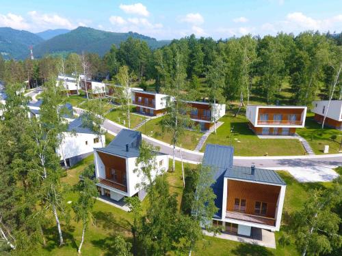 an aerial view of a village with houses at Tarcin Forest Resort & Spa Sarajevo - MGallery Collection in Tarčin