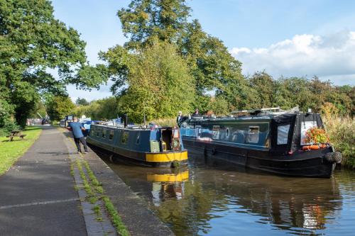 two boats are docked on a canal at Ellesmere Hotel in Ellesmere