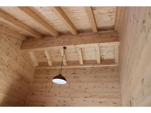 aendant light hanging from a wooden ceiling in a room at Feriendorf X-Alp Lodges Ötztal in Sautens