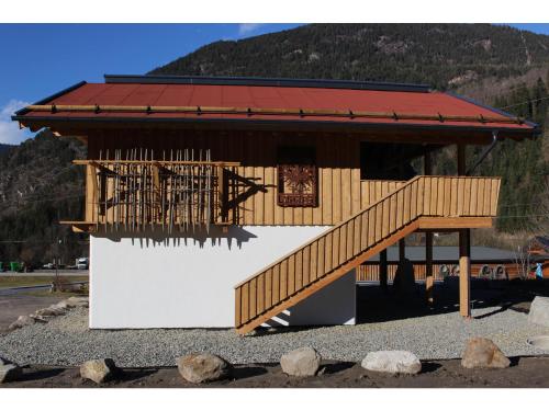 a small building with a staircase in front of it at Feriendorf X-Alp Lodges Ötztal in Sautens