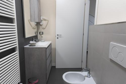 a small bathroom with a sink and a toilet at Maison Gentile in Lucca