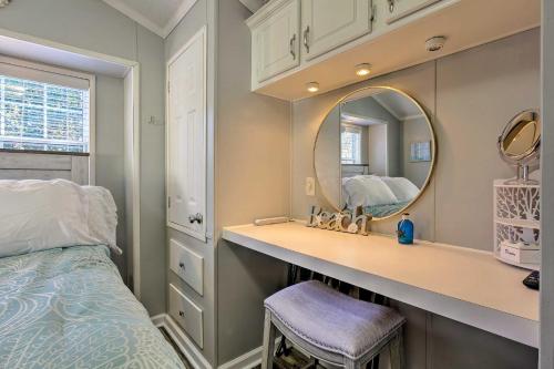 a bedroom with a bed and a vanity with a mirror at Bright Miramar Tropical Cabana, 2 Blocks to Beach! in Destin