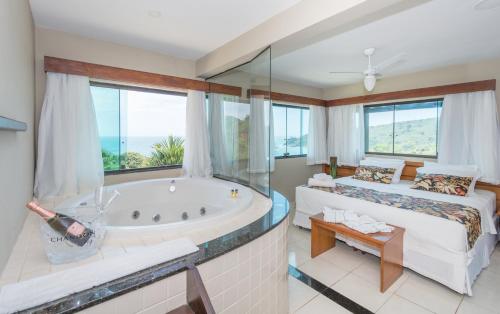 Ένα ή περισσότερα κρεβάτια σε δωμάτιο στο Hotel Pousada Brava Club