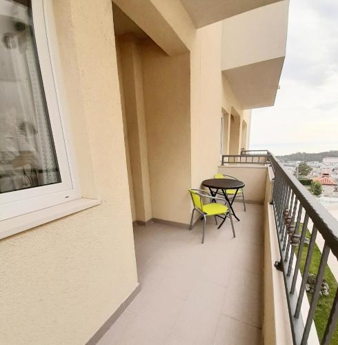 a balcony with a table and chairs on it at Apartments Akmadzic in Makarska