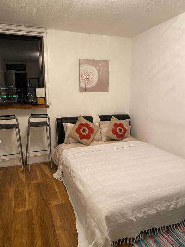 a bedroom with a bed with red pillows on it at Room in Central London Overview Thames in London