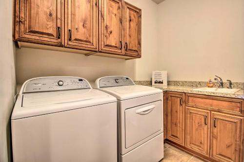a white washer and dryer in a kitchen with wooden cabinets at Lakefront Giants Ridge Retreat Near Ski and Golf! in Biwabik