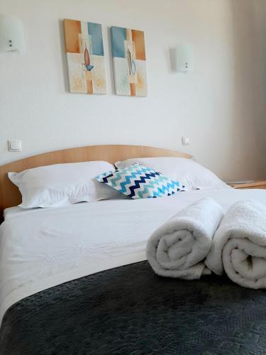 a bedroom with a bed with towels on it at Apartments Akmadzic in Makarska