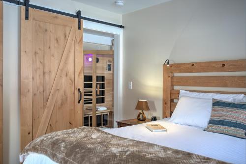 a bedroom with a large bed with a wooden door at The Woodstocker B&B in Woodstock