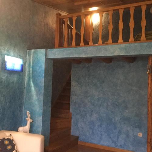 a living room with a loft bed and a staircase at Casa Carbonero in Lascuarre