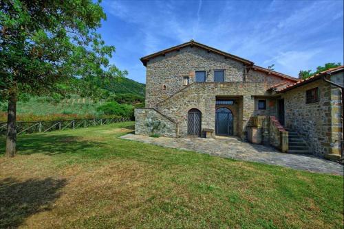 an external view of a stone house with a yard at Agriturismo Fattoria Celle in Figline Valdarno