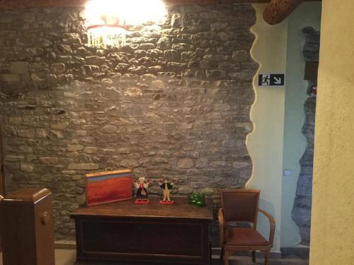 a room with a table and a stone wall at Casa Carbonero in Lascuarre