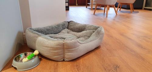 a dog bed sitting on the floor in a room at Riverside Marina Apartments in Lanesborough