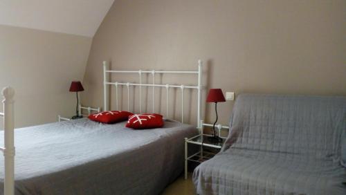 - une chambre avec un lit doté d'oreillers rouges dans l'établissement Les Milles Gouttes Résidence La Feuillée, à Le Mont-Dore