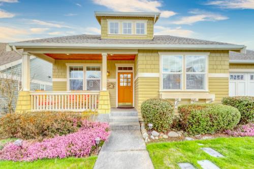 a yellow house with a yellow door and bushes at Bonne Chance Cottage in Sequim