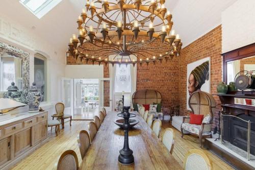 a large dining room with a large chandelier at Rent your own Historic Hotel for Holidays & Events in Maldon