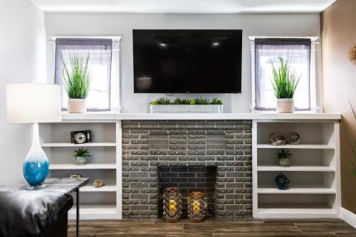 a living room with a fireplace with a tv above it at Long Beach Duplex King Bed Pet Friendly Nurses Surgeon Business Travelers Near St Marys Medical Center & Downtown in Long Beach