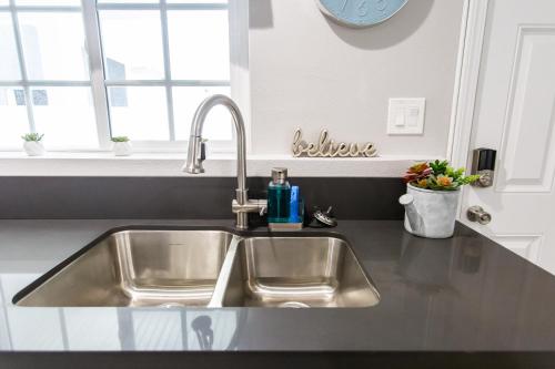 a stainless steel sink in a kitchen with a window at Long Beach Duplex King Bed Pet Friendly Nurses Surgeon Business Travelers Near St Marys Medical Center & Downtown in Long Beach