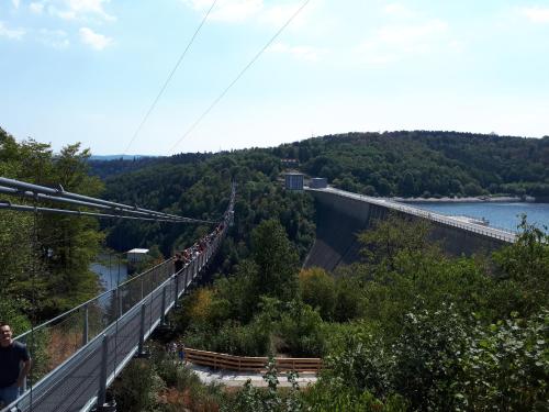 a group of people on a suspension bridge over a river at Traumharz in Sankt Andreasberg