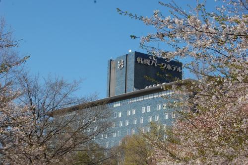 a tall building with a sign on the top of it at Sapporo Park Hotel in Sapporo