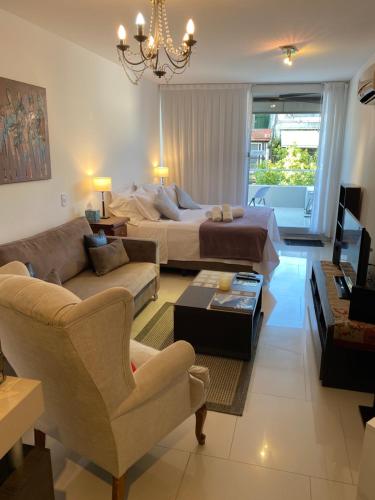 a living room with a bed and a couch at Palermo Soho Apartment Guemes in Buenos Aires