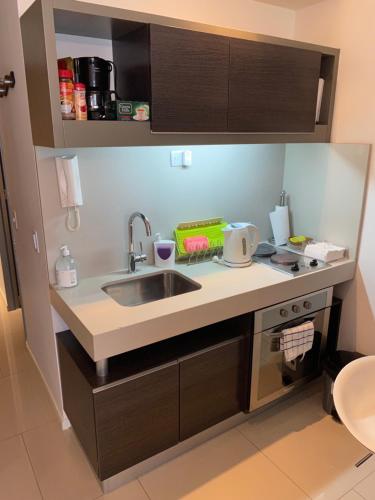 a kitchen with a sink and a counter top at Palermo Soho Apartment Guemes in Buenos Aires