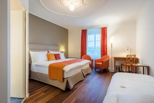 a hotel room with two beds and a window at Hotel Des Alpes in Luzern