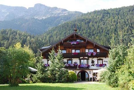 a large building with flowers on the front of it at Alpenhotel Speckbacher Hof in Gnadenwald