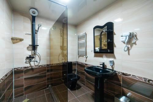 a bathroom with a sink and a shower at Georgia Gold in Gori