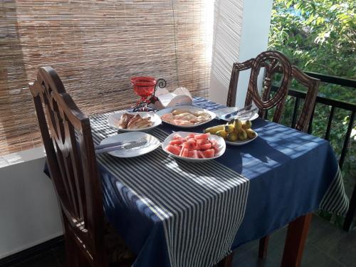a blue and white table with plates of food on it at B & B CHARM in Dickwella