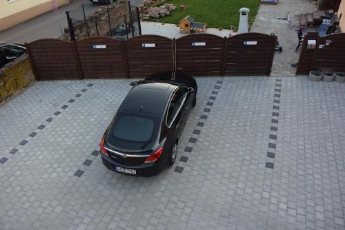 a car parked in a parking lot next to a fence at Ferienwohnung Misita in Rust