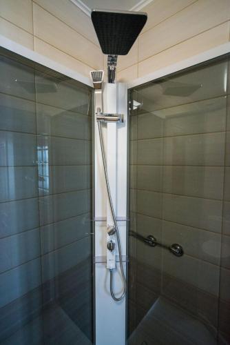 a shower with a shower head in a bathroom at Комплекс відпочинку Пампушка & Подушка in Odesa