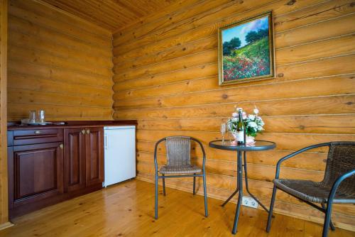 a dining room with a table and chairs at Комплекс відпочинку Пампушка & Подушка in Odesa