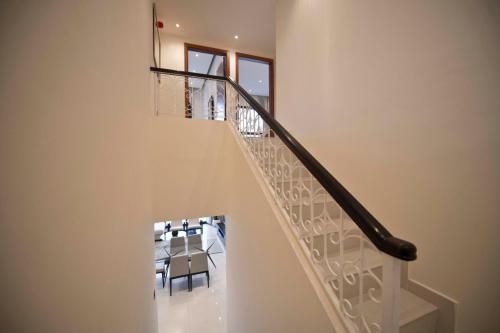 a staircase with a table and a dining room at Private 003 - Property Advisers in Dibba