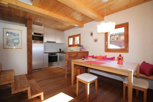 a kitchen with a wooden table and a dining room at Stadel Ritz in Niederwald