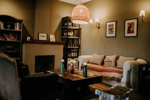 a living room with a couch and a coffee table at Finca el Maitén Hotel Boutique in San Rafael