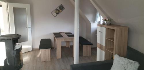 a living room with a table and a stairway with a table at Fewo Mehrwald in Korbach