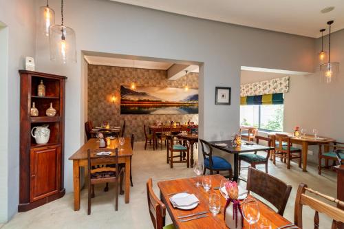 a dining room with wooden tables and chairs at Tulbagh Boutique Heritage Hotel in Tulbagh