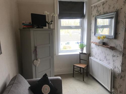 a living room with a couch and a window at Craiglands Bed and Breakfast, Grassington in Grassington