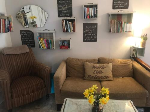 a living room with a couch and a table with flowers at Craiglands Bed and Breakfast, Grassington in Grassington