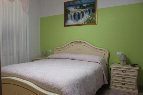 - une chambre avec un lit et une peinture murale dans l'établissement Villa Lucia B&B, à Tortoreto Lido