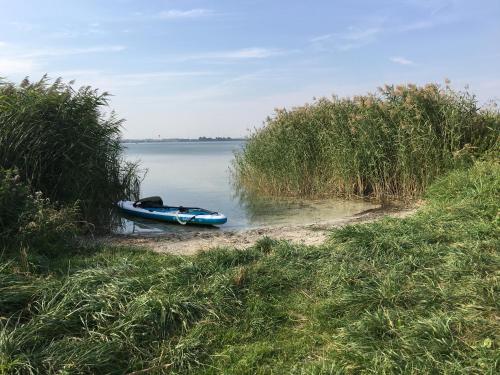 a boat sitting on the shore of a body of water at Apartment Amylee in Strehlow