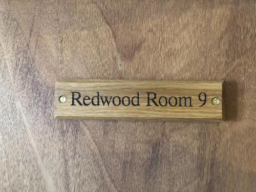 a wooden sign with the word reedoked room at The Fossil Tree Hotel in Blackpool