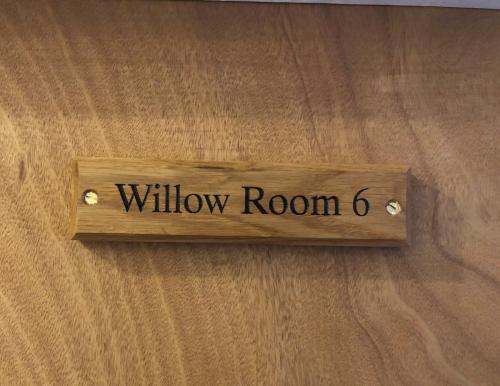 a wooden sign that reads window on a wall at The Fossil Tree Hotel in Blackpool