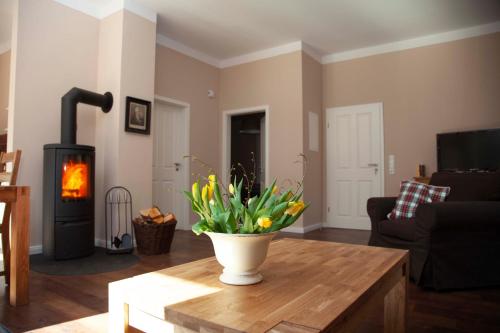 a living room with a vase of flowers on a table at Gästehaus Gut Füchtel und Gut Welpe in Vechta
