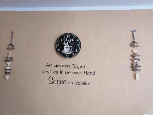 a picture of a plate on a wall with earrings at Pension Mien Fründt in Baabe