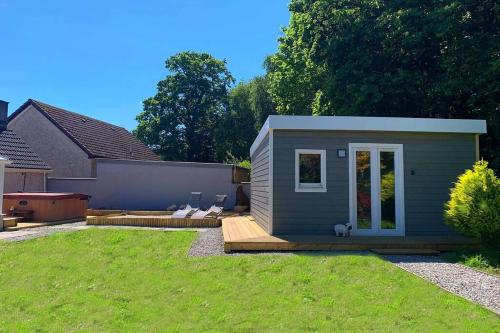 a tiny house in a yard with a backyard at Highland HotTub Retreat, on NC500 in Inverness