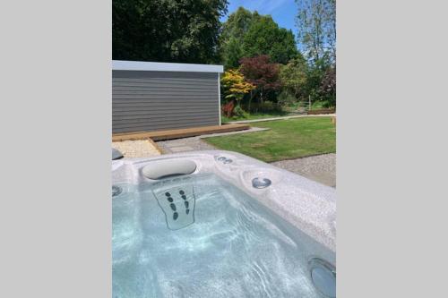 a hot tub in the backyard of a house at Highland HotTub Retreat, on NC500 in Inverness