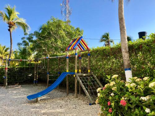 a playground with a slide in a park at Blue Apartahotel in Coveñas