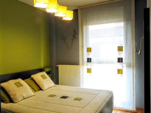 a bedroom with a large bed and a window at Jardines de Viana in Viana