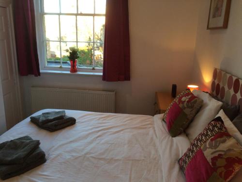 a bedroom with a white bed with two towels on it at City Centre - The Old Committee Room-free parking in York
